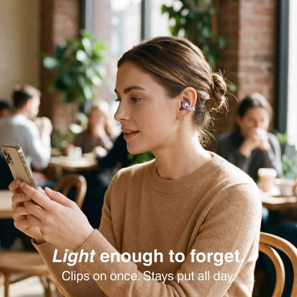 Woman wearing lightweight clip-on earbuds in a cafe